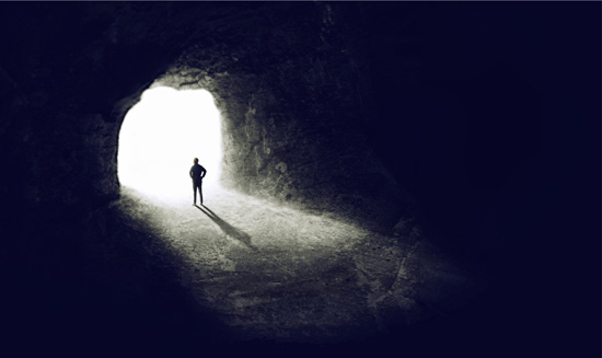 Drawing a man inside a cave looking out into daylight representing the darkness of depression.