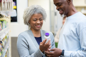 Black couple look at antidepressant bottle after a depression diagnosis.