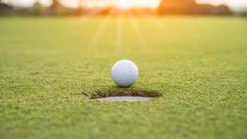 Golf ball on putting green