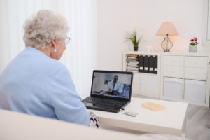 Older woman on a video call with her doctor, using telehealth for her geriatric depression.