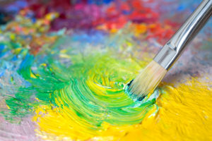 Paint brush with colorful, bright yellow and greens, showing how art can help people cope with depression.
