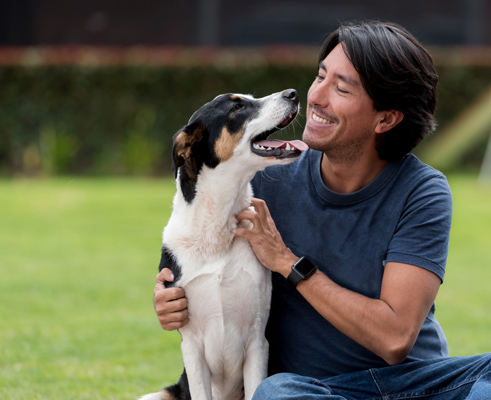 man petting his dog, which has a positive impact on his mental health