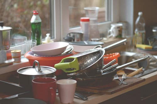 Cluttered sink of dirty dishes, demonstrating how depression can interfere with the ability to complete everyday tasks.