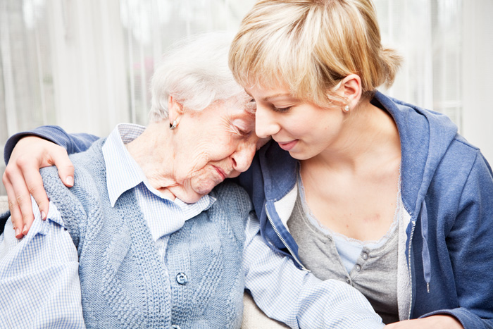 Woman comforts her older loved one as they look for treatment for geriatric depression