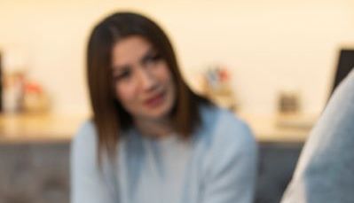 Woman blurred in the background gestures with hands during at talk therapy session for depression treatment.