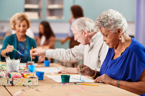 Elderly people painting together to prevent loneliness and depression