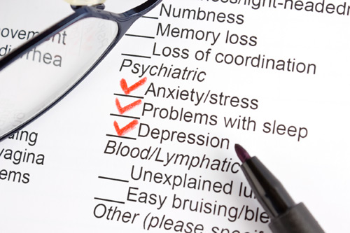 Checklist on doctor’s evaluation form showing anxiety and depression checked in red ink.