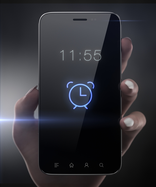Hand holding a smartphone with an alarm ringing showing how to set time limits on social media.