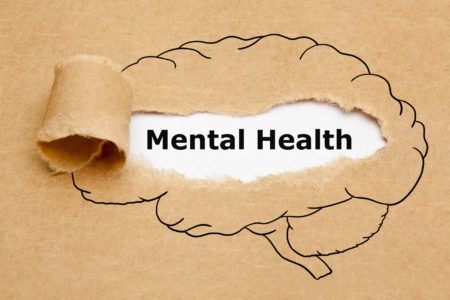 Rippled construction paper with illustration of brain reveals words “mental health” underneath