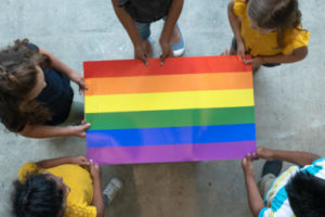 Students holding a Pride flag
