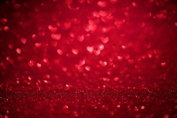 Red confetti hearts fall onto a red background illustrating whether taking antidepressants will impact libido
