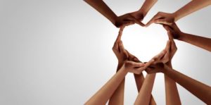 Diverse hands form a heart against a light background, demonstrating how to take action against mental health stigma