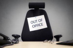 Business chair with "out of office" sign, illustrating how important it is to take mental health days off work.