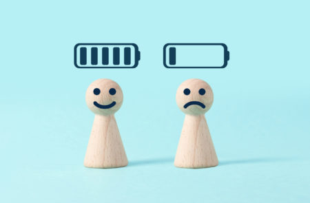 Two figures, one smiling with full battery signal above them, one frowning with nearly depleted battery signal, illustrating caregiver burnout