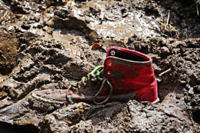 Red high-top sneaker stuck in mud, showing how clinical depression can feel.