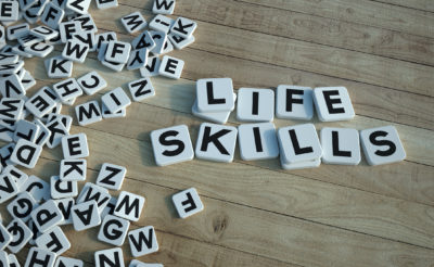 Picture of letter tiles forming the words “life skills” showing how therapy can help you understand how to improve your outlook on life.