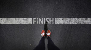 Woman wearing red shoes at FINISH line, illustrating the mnemonic “FINISH” to identify symptoms of antidepressant withdrawal