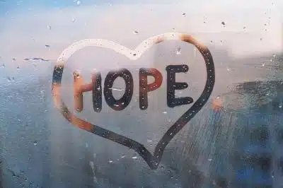 Handwritten word “Hope” in shape heart on misted glass showing the importance of acknowledging and getting treatment for passive suicidal thoughts.