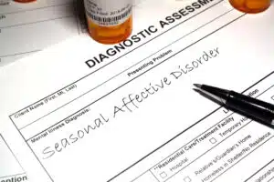 A prescription pad with Seasonal affective disorder written on it indicating the diagnosis of SAD depression