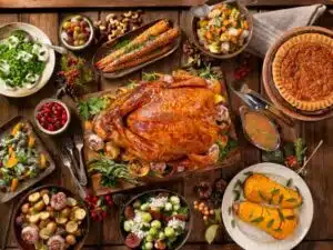 Holiday table overflowing with abundance of food showing how holiday indulgence may negatively impact mental health.