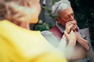 Senior male kisses the hand of his wife, showing the importance understanding geriatric depression.