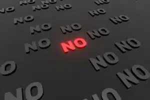 The word “no” repeated on a black background showing the importance of declining invitations where it may impact your mental health