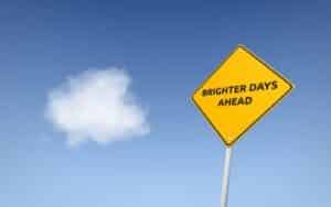 Road sign against blue sky that says “Brighter Days Ahead” showing hope after depression diagnosis