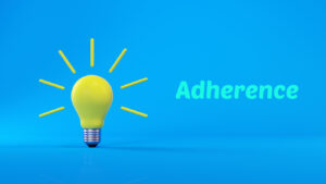 3d lightbulb against blue background with adherence, illustrating importance of mental health medication adherence 