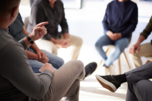 A group of men in a talk therapy session for their mental health 