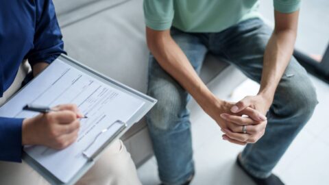 Young man discussing his mental health treatment options with a mental health professional